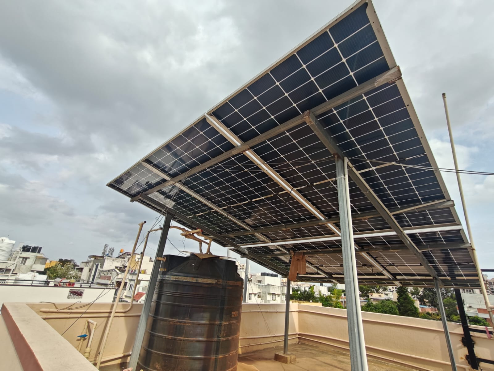 Raised solar structure over a water tank