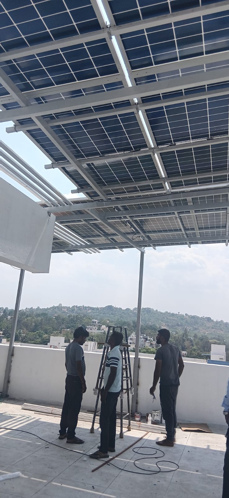 Vyshri team inspecting an elevated solar installation